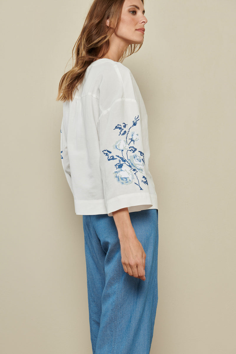 White tunic blouse with blue broderie