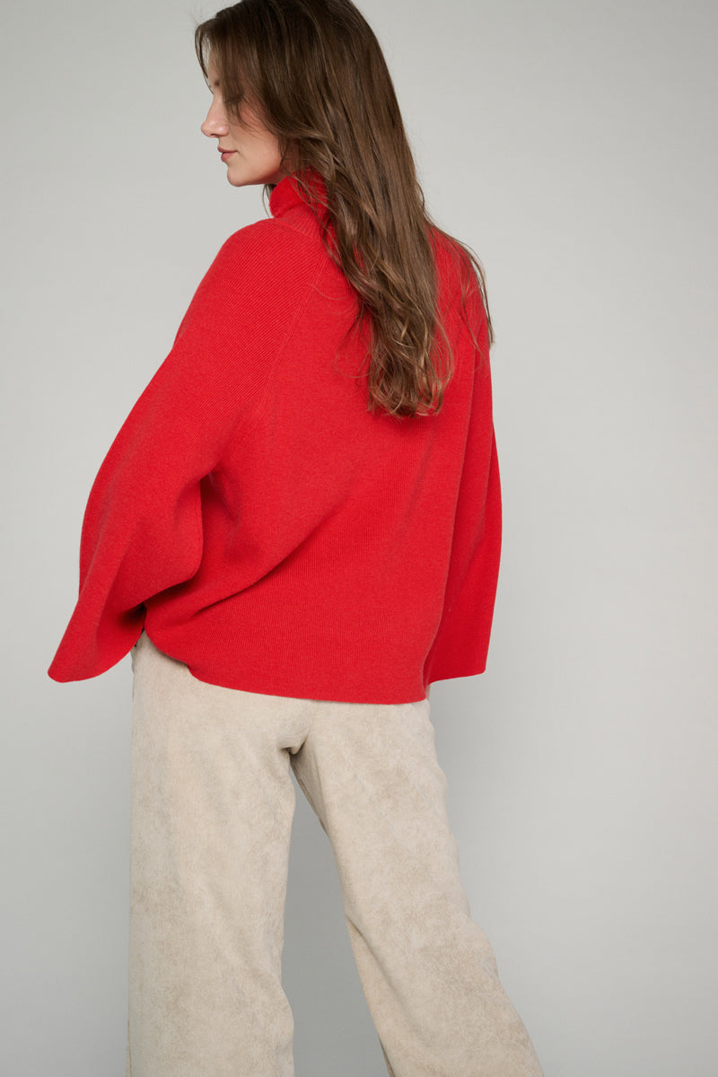 Red pullover with flared sleeves