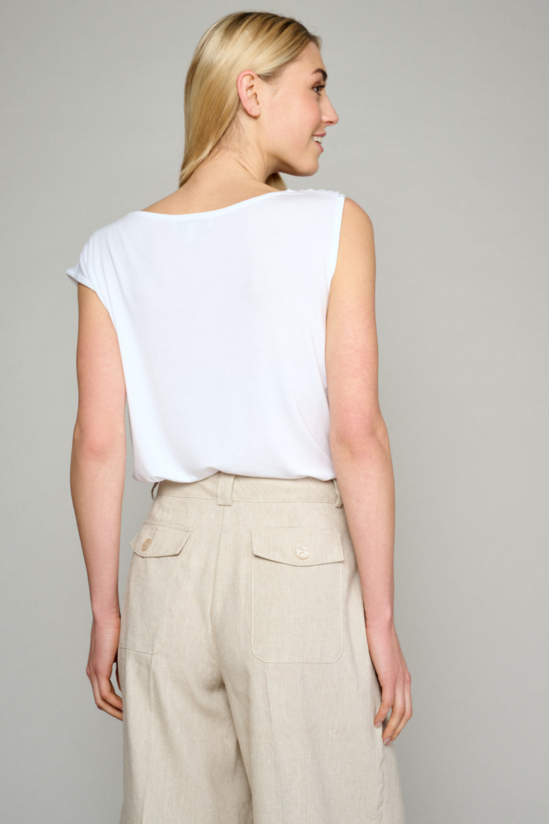 White top with detail at the shoulder