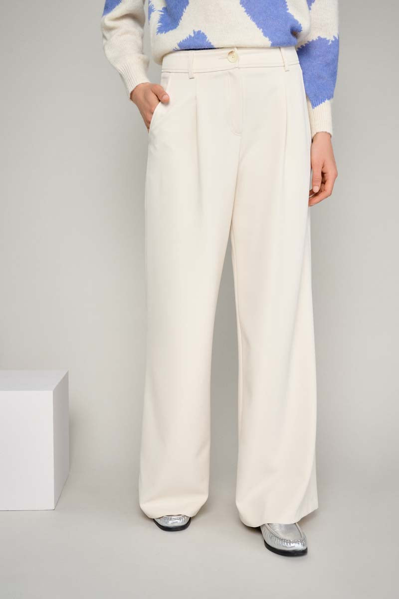 Wide cream-colored trousers