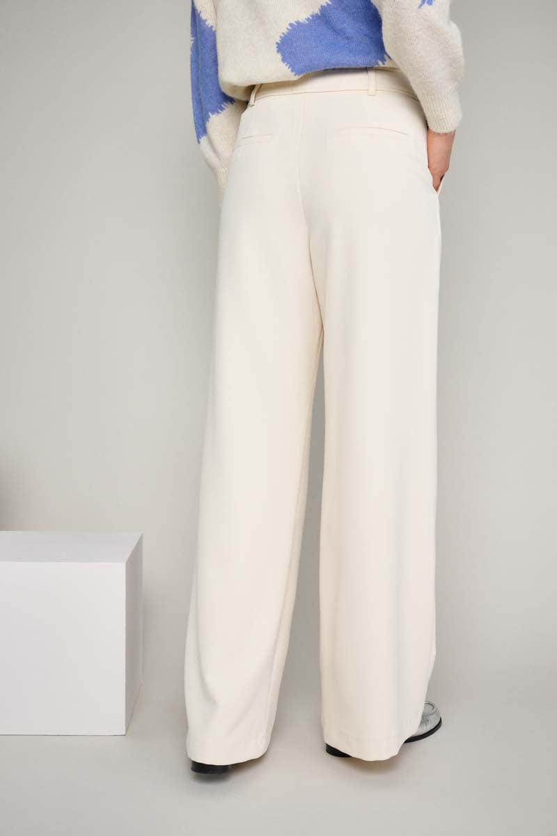 Wide cream-colored trousers
