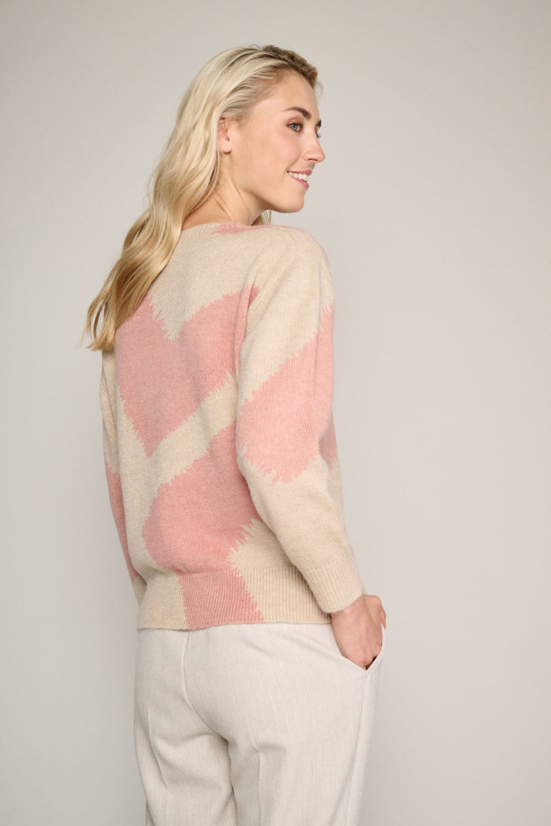 Sand-coloured jumper with an abstract pink print.