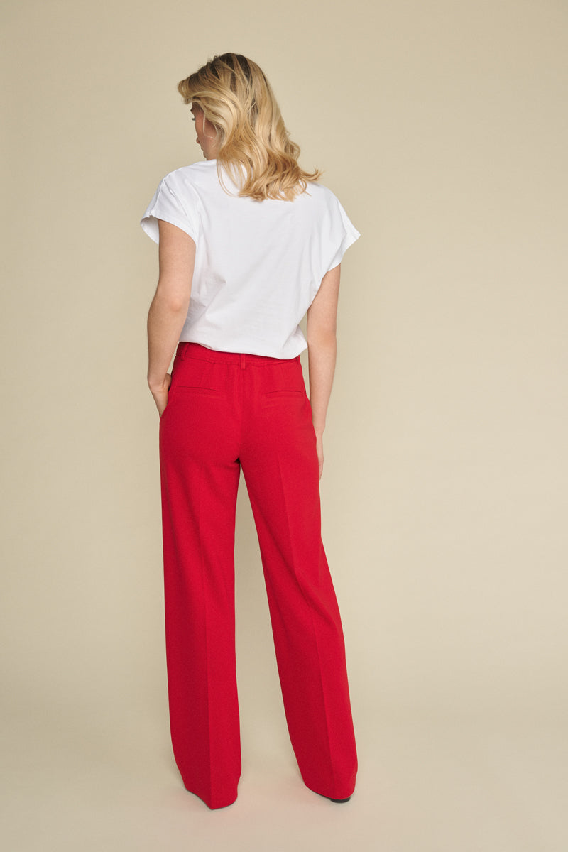 Red straight-leg trousers with subtle elastic at the back