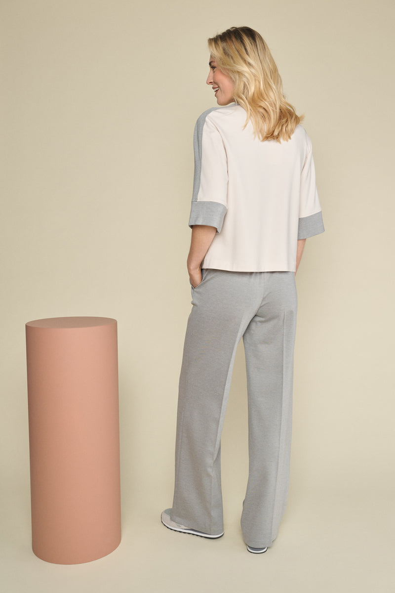 Grey straight-leg trousers with subtle elastic at the back of the waist