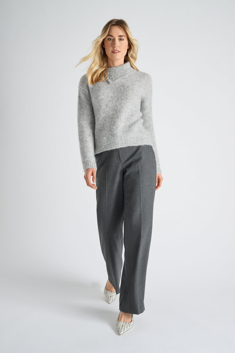 Grey sweater with brooch on stand-up collar