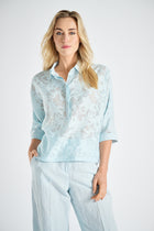 Light blue polo shirt with transparent flowers