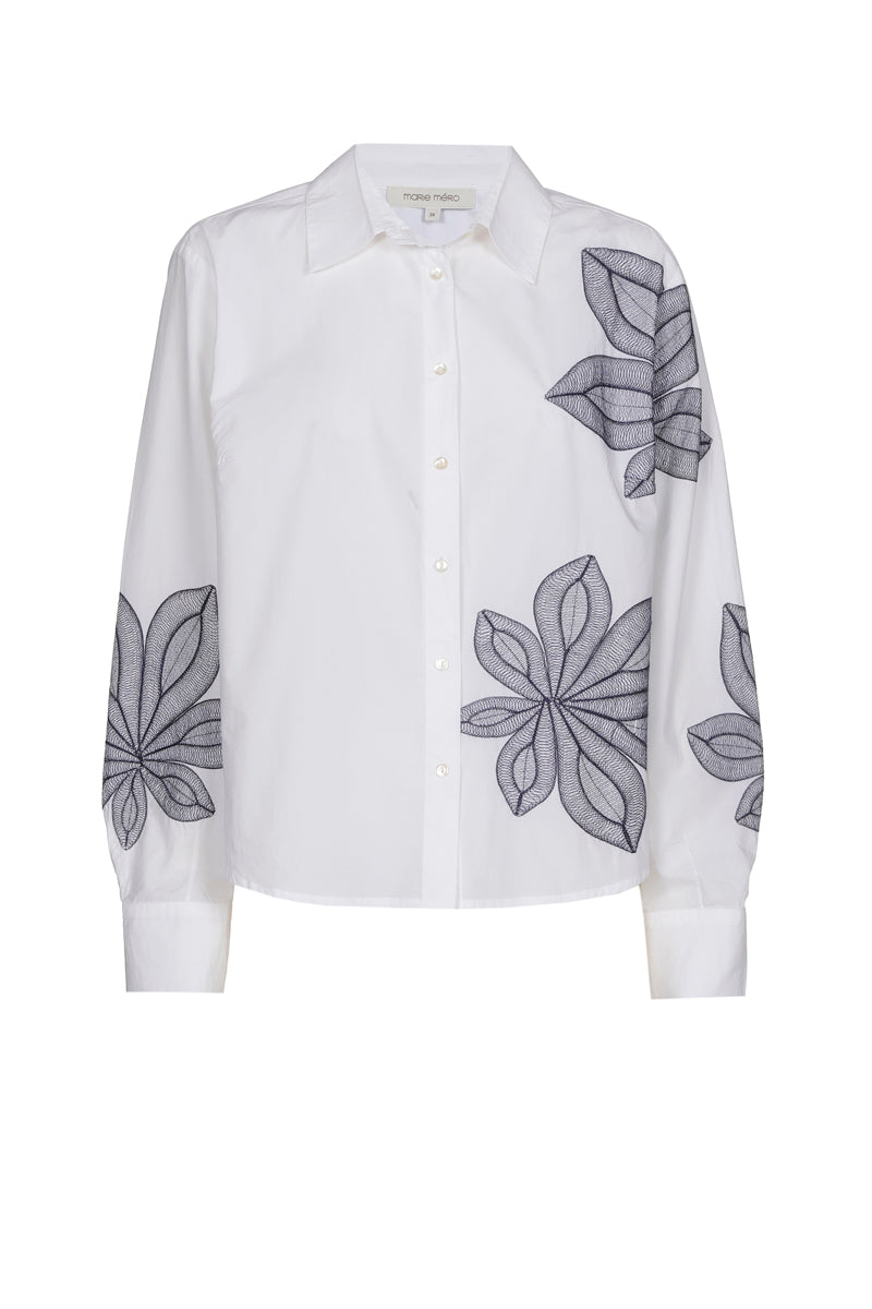 Chemisier blanc avec fleur bleue