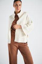 Buttoned ecru cape-sweater with turtleneck