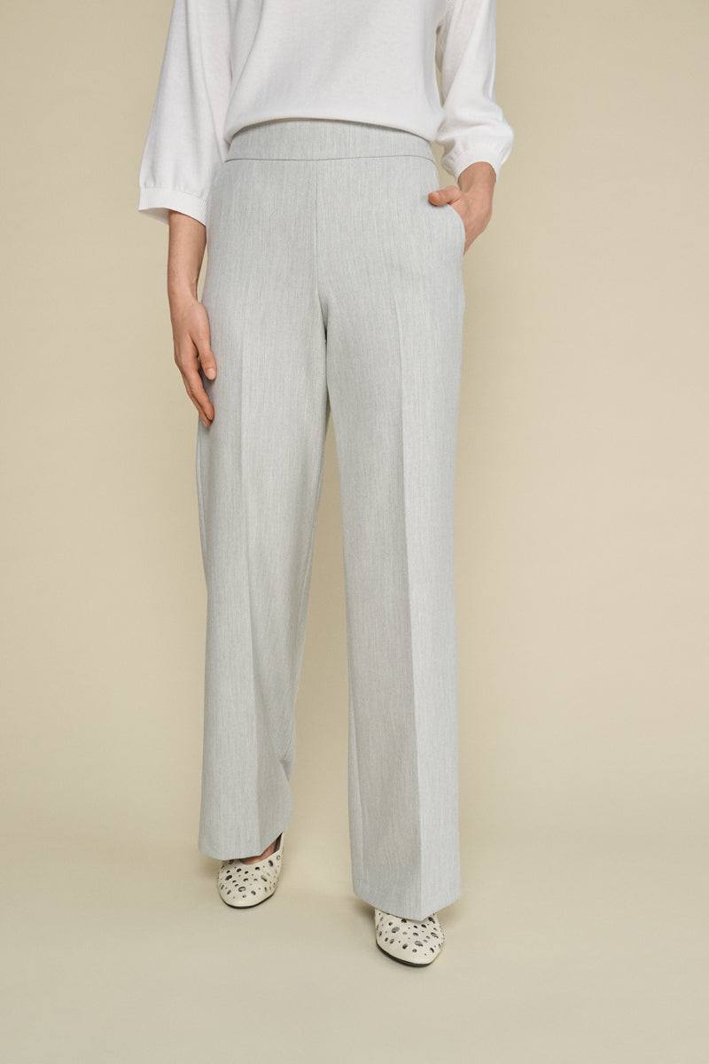 Wide grey trousers and elastic at the back of the waist